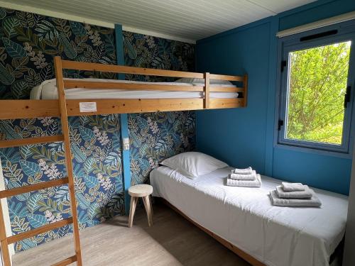 a bedroom with two bunk beds and a window at Le Pré Marin in Sotteville-sur-Mer