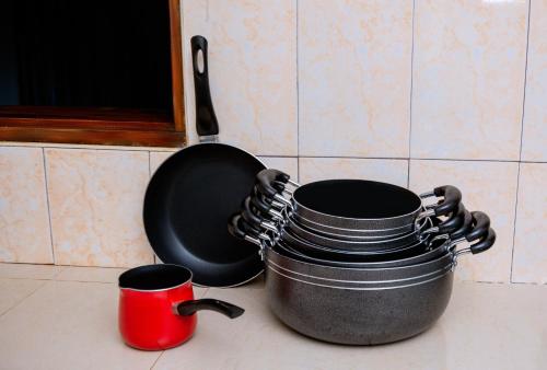 two pots and pans sitting on a kitchen counter at The Mbuya Residence in Kampala