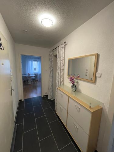 Zimmer mit einer Kommode und einem Spiegel an der Wand in der Unterkunft Sana Ferienwohnung in Oberhausen