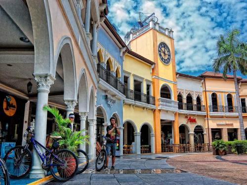 a building with a clock tower in a street at Avant Apartments at The Fort in Manila