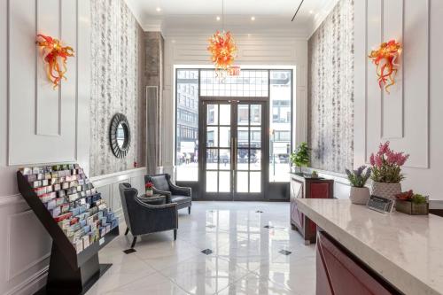 a lobby with a store with chairs and a window at Broadway Plaza Hotel in New York