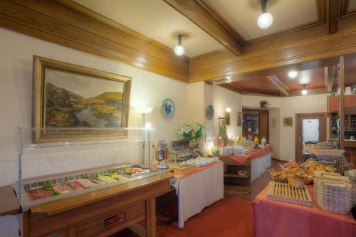 a restaurant with a buffet line with food on display at Waldhotel Sonnenberg in Bollendorf