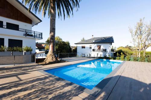 a swimming pool in front of a house at Arroka in Hondarribia