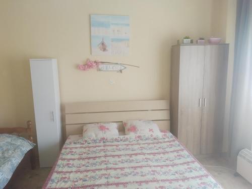 a small bedroom with a bed and a cabinet at Marko Apartments in Struga