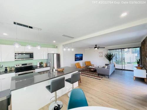 a large kitchen and living room with a counter top at Walkable OTS, Heated Poolside Mid Century Condo in Scottsdale