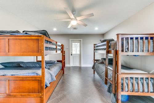 a bedroom with bunk beds and a ceiling fan at Luxe Lake Charles Escape with Home Theater! in Lake Charles