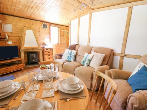 a living room with a table and a couch at Brook Lodge in Llandysul