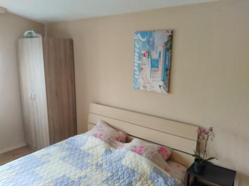 a bedroom with a bed and a picture on the wall at Marko Apartments in Struga