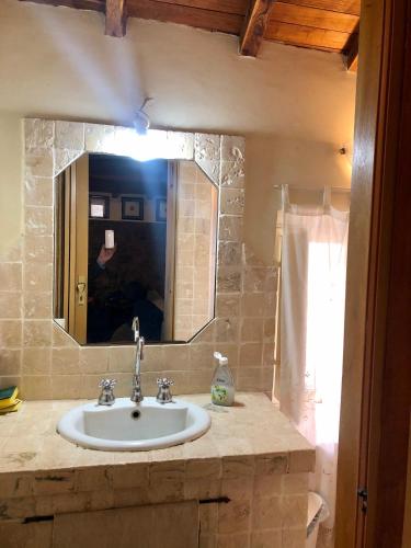 a bathroom with a sink and a mirror at VITERBO ART APARTMENTS in Viterbo