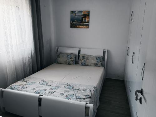 a small bedroom with a bed in a room at Arber's Home in Sarandë