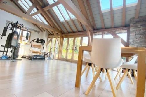 a dining room with a table and a chair at Ty Hobi Bach - at the foot of the Black Mountains in Brecon