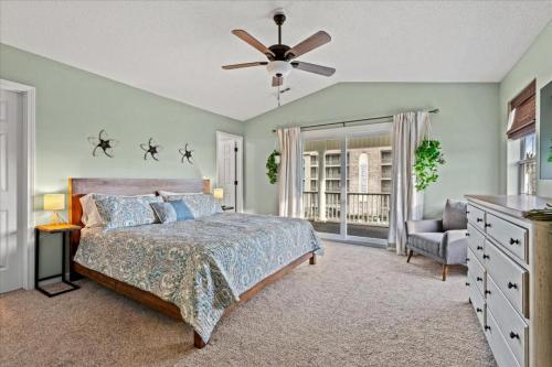 a bedroom with a bed and a ceiling fan at Mahalo House in Myrtle Beach