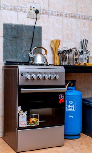 a stove with a tea kettle on top of it at The Mbuya Residence in Kampala