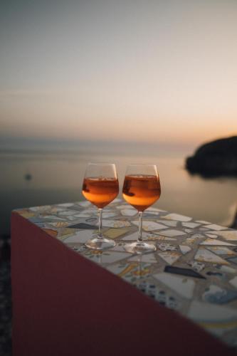 two wine glasses sitting on top of a table at Hotel Villa Maria in Ischia