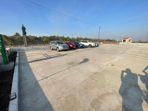 a shadow of a person taking a picture of a car at VITS Jamnagar in Jamnagar