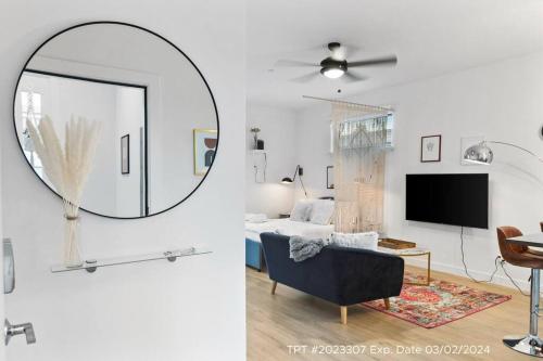 a living room with a mirror and a room with a bed at Poolside Studio w Rooftop Deck - Walk to Old Town in Scottsdale