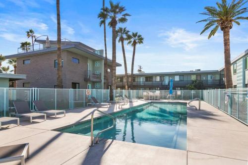 a swimming pool with chairs next to a building at Poolside Studio w Rooftop Deck - Walk to Old Town in Scottsdale