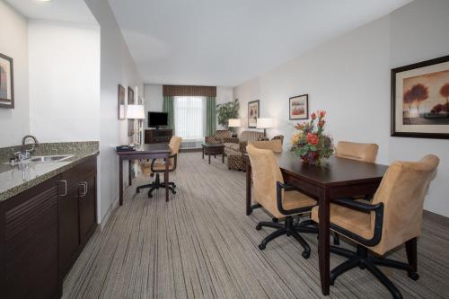 a kitchen and living room with a table and chairs at Holiday Inn Express & Suites Oro Valley-Tucson North, an IHG Hotel in Oro Valley