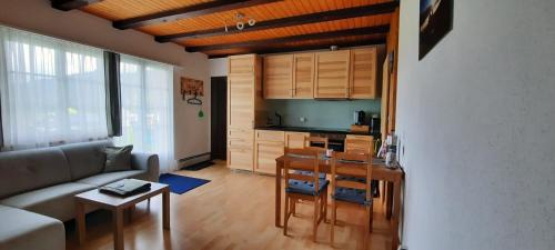 a living room with a couch and a table at Ferienwohnung Schafbergblick in Wildhaus