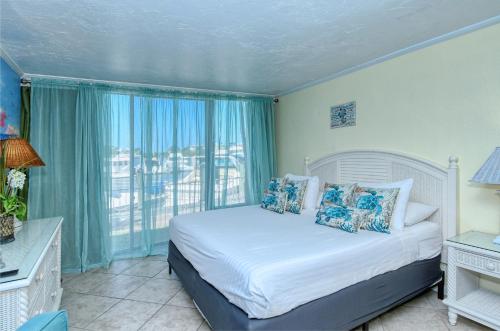 a bedroom with a bed and a large window at Waterfront Room, Heated Pool, Tiki Bar & Grill in Sarasota