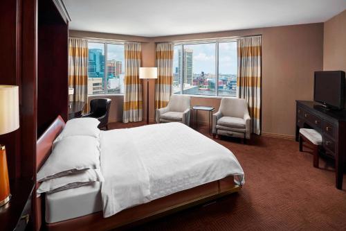 a hotel room with a bed and a large window at Sheraton Inner Harbor Hotel in Baltimore