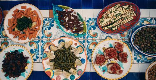 a table with plates of food on a table at Hotel Villa Maria in Ischia