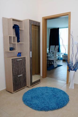 a living room with a blue rug and a mirror at Sea Dream Rental Apartments in Varna City