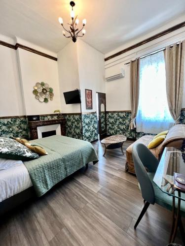 a bedroom with two beds and a fireplace at Hôtel de Charme Le Provence in Salon-de-Provence