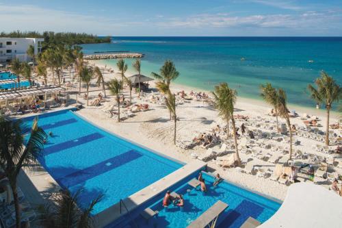 an aerial view of the beach and swimming pool at a resort at Riu Reggae - Adults Only - All Inclusive in Montego Bay
