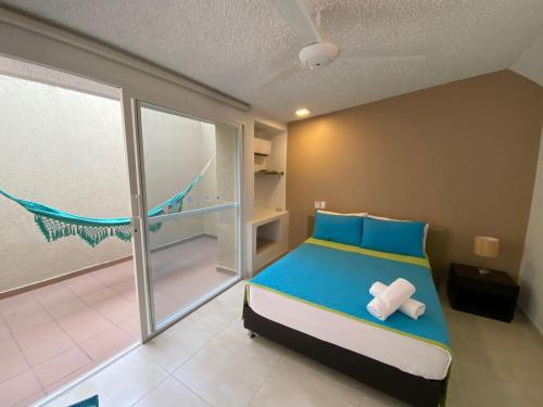 Cama o camas de una habitación en Hotel TACALOA INN EXPERIENCE