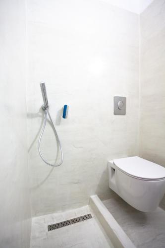 a white bathroom with a shower and a toilet at Stella's place, Vlichada in Vlychada