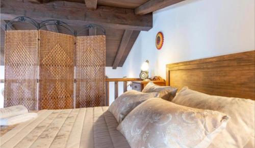 a bedroom with a large bed with a wooden headboard at Casa la serena in Iznájar