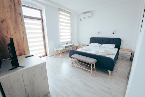 a bedroom with a bed and a tv in it at Nestor Apartments in Bitola