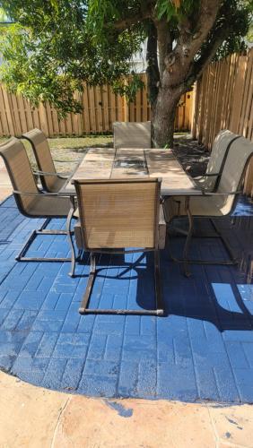 a wooden table and chairs on a patio at Tiny Efficiency All-In-1 in Sunrise