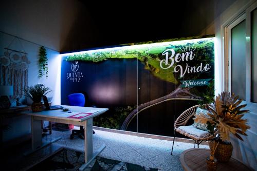 a room with a table and a sign on a wall at Quinta da Paz Azores in Pico da Pedra