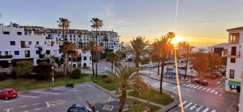 an aerial view of a city street with palm trees at Puerto de la Duquesa Sea Views in Manilva