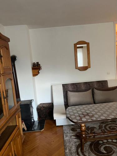 een woonkamer met een bank en een tafel bij Rustic home Visoko in Visoko