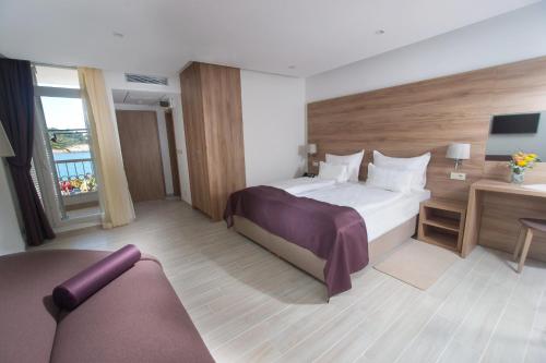 a hotel room with a bed and a desk at Hotel Biokovo in Makarska