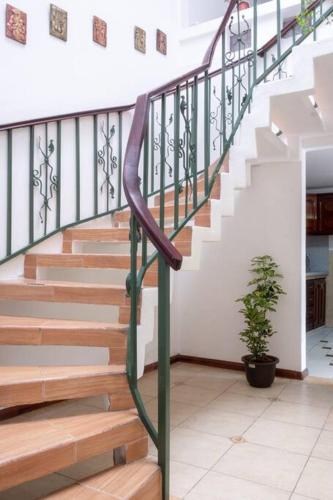 a staircase in a house with a metal railing at Cozy & Spacious House-Near the Centro in Cuenca