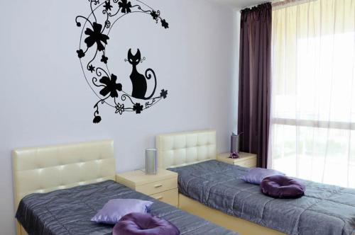 a bedroom with two beds with purple pillows at Sea Dream Rental Apartments in Varna City