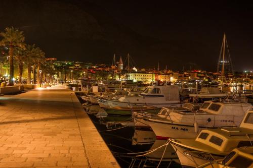 a group of boats docked in a harbor at night at Hotel Biokovo in Makarska