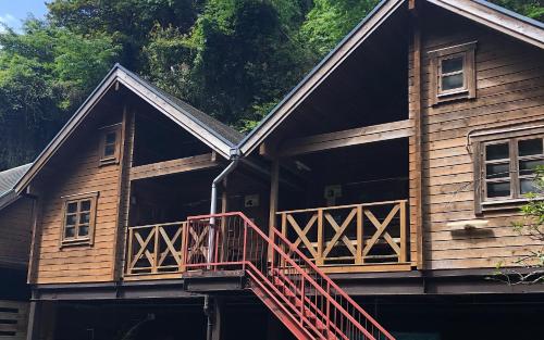 a log cabin with a deck and a balcony at village yumigahama - Vacation STAY 49349v in Minato