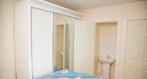 a bathroom with a mirror and a sink and a toilet at White House in Netherton