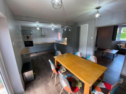 a kitchen and dining room with a wooden table and chairs at 10 Tarleton Avenue, Woodhall Spa in Woodhall Spa