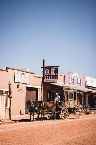 a horse drawn carriage on the side of a street at Silver Spur Homestead Luxury Glamping -The Tombstone in Tombstone