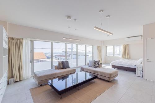 a living room with a bed and a couch and a table at MARSOL C,S,Beach hotel - Vacation STAY 50798v in Chigasaki