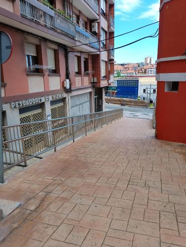 an empty street in front of a building at Astillerogane in Bermeo