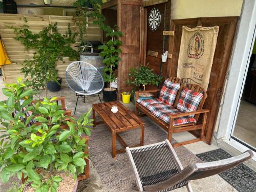 a patio with a chair and a table and chairs at Maison 6 places, en plein cœur de l’Ariège, proche ski et nature in Lesparrou