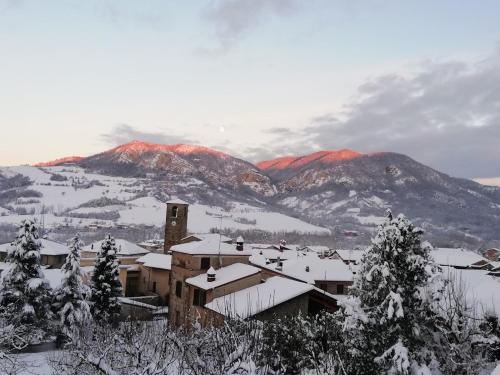 a snow covered town with mountains in the background at La Pomella in Ponte Nizza