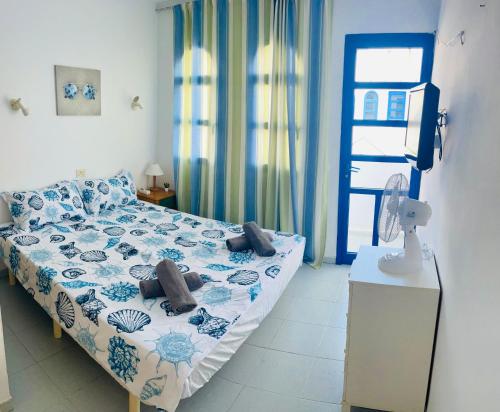 a bedroom with a bed and a table with a fan at Maspalomas Casa Oceano in Maspalomas